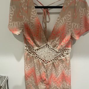 Romper cream and orange size small brand is Illa Illa